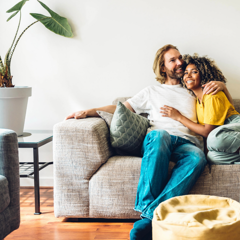 young couple sitting on a sofa young couple sitting on a sofa